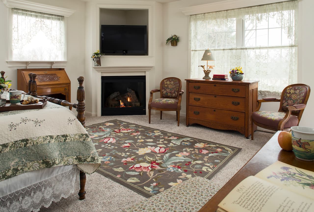 King bed in front of TV and Fireplace