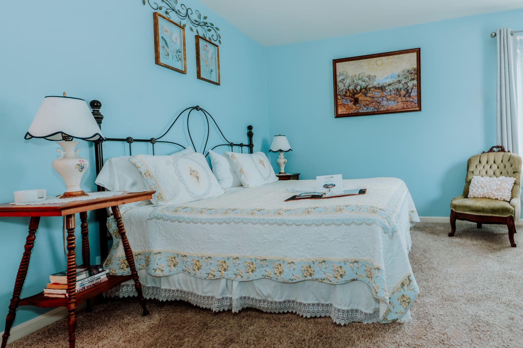 Blue-toned guest room with king bed and serene wall mural