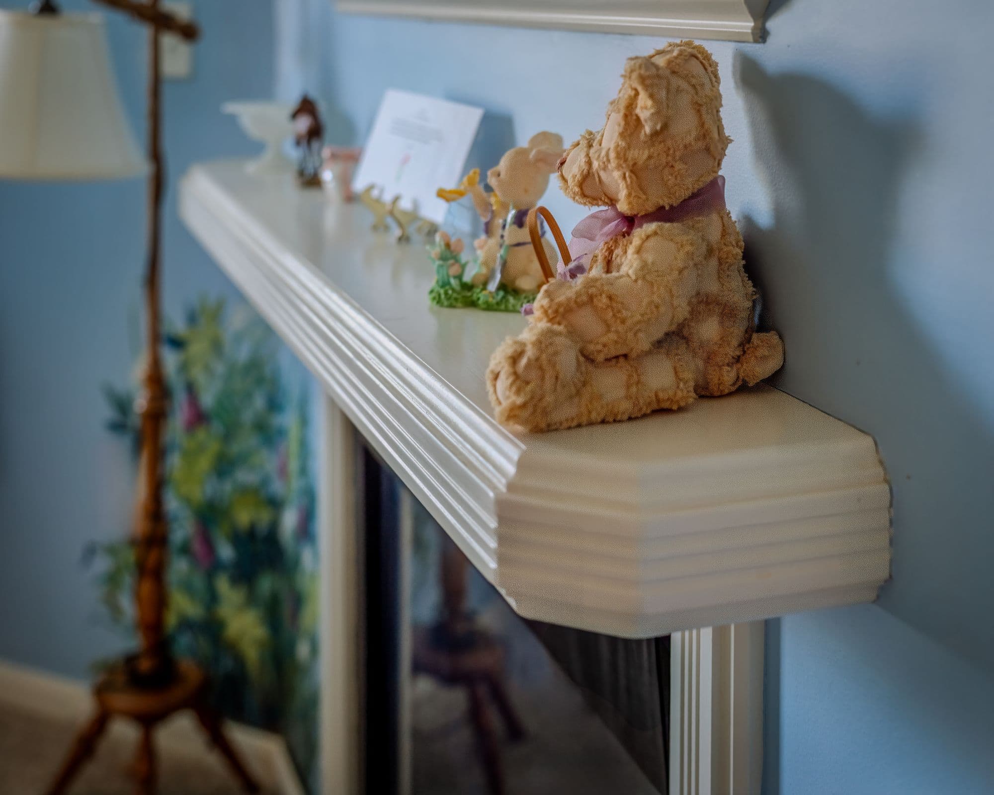 Corner fireplace in serene blue guest room with calming mural and cozy ambiance