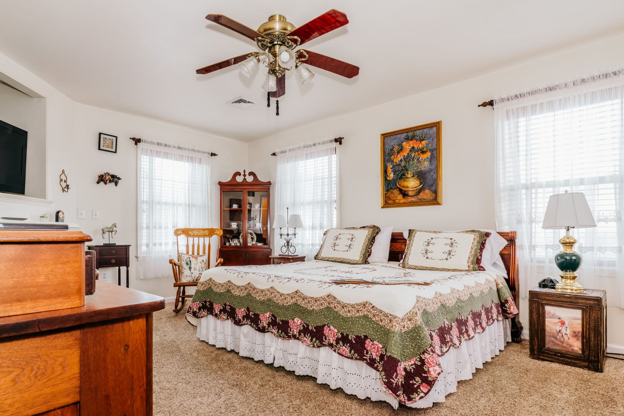 King bed in a serene second-floor guest room with equestrian-inspired décor