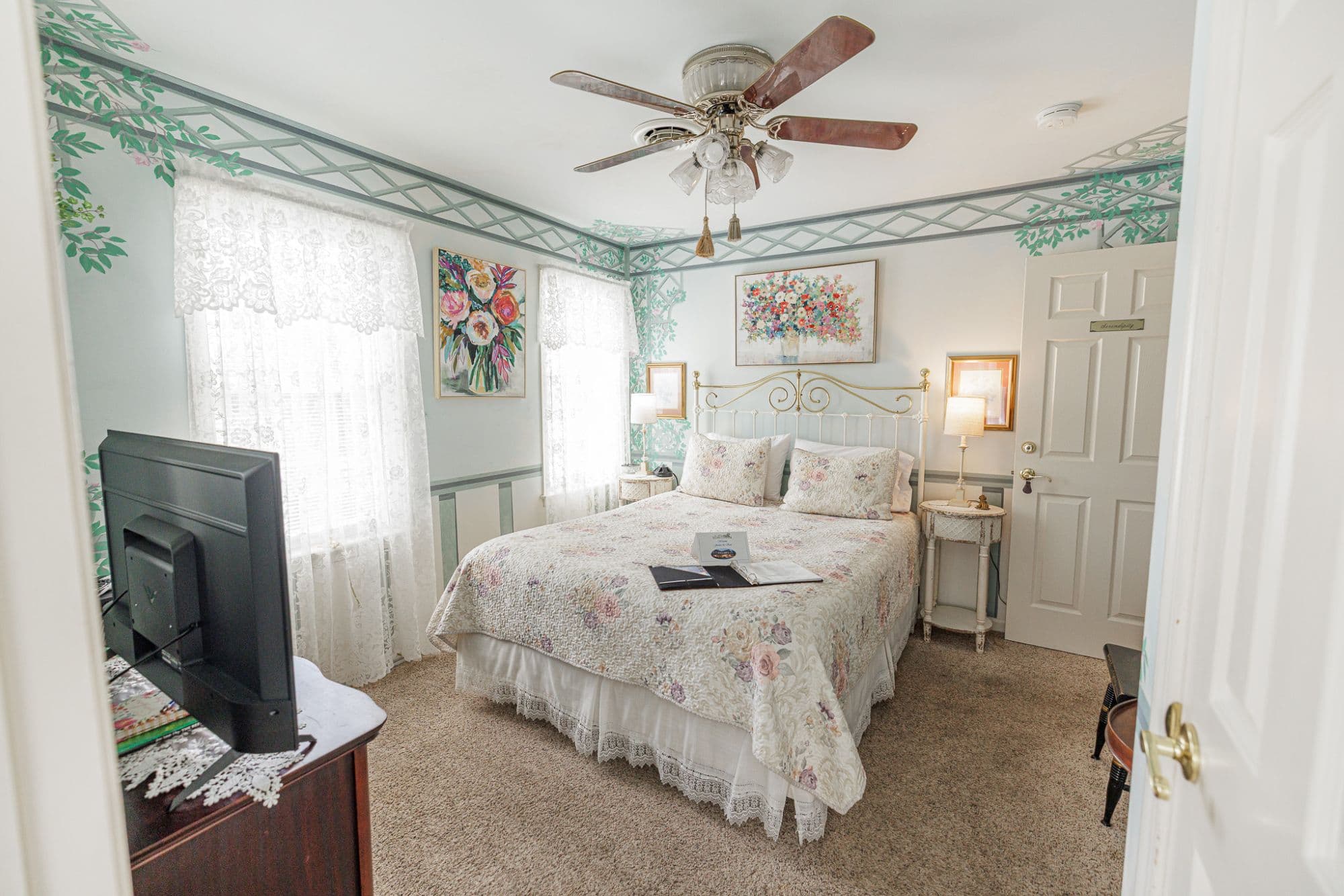 Queen bed, television and dresser