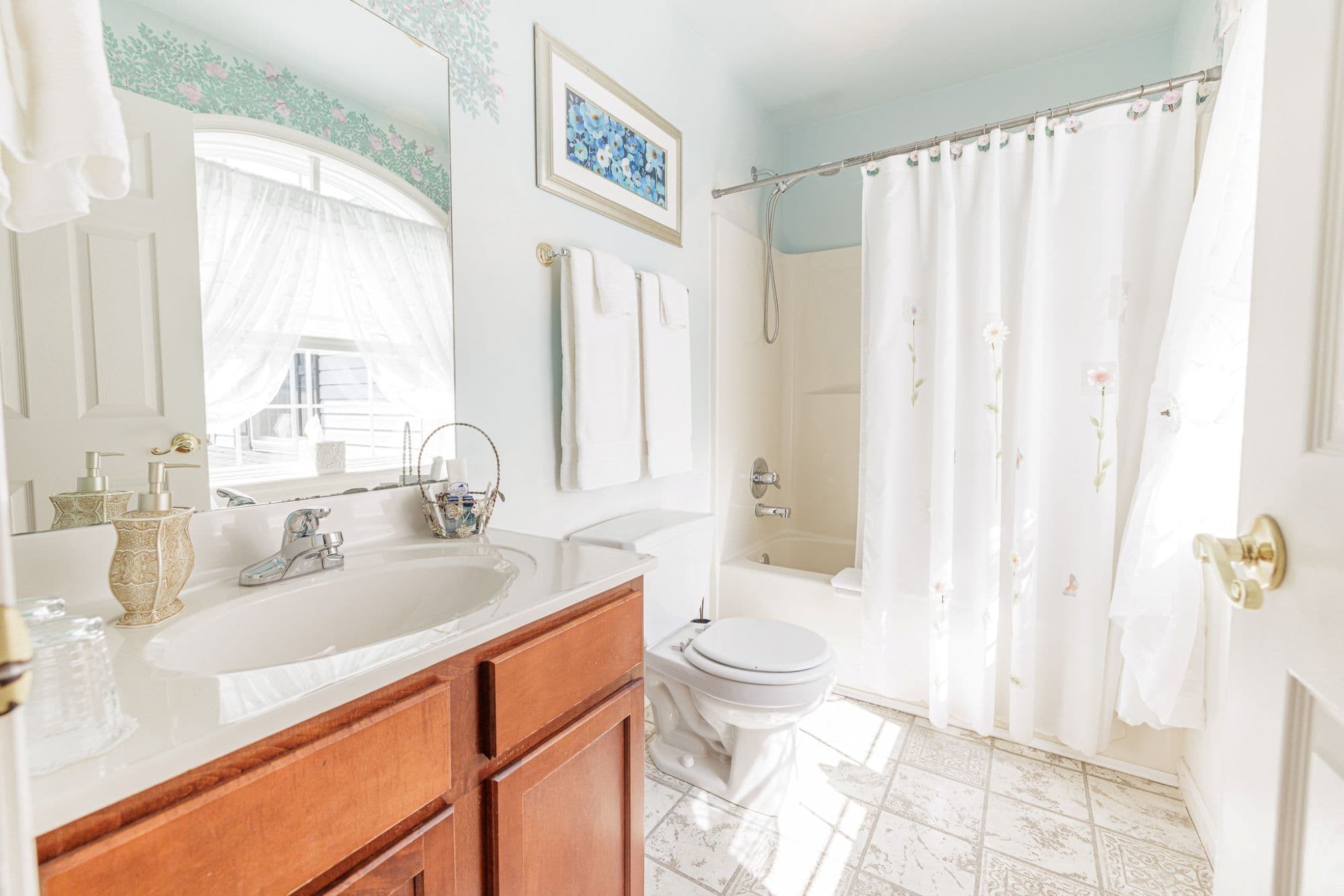 Private bathroom in cozy second-floor guest room with tub and shower combination