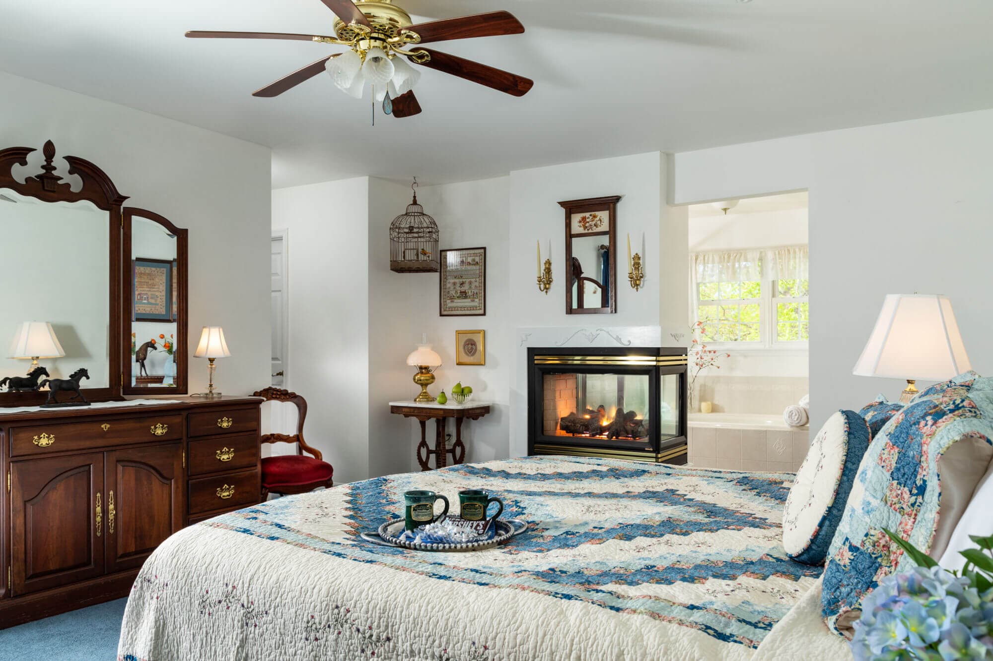 King bed with overhead fan and fireplace