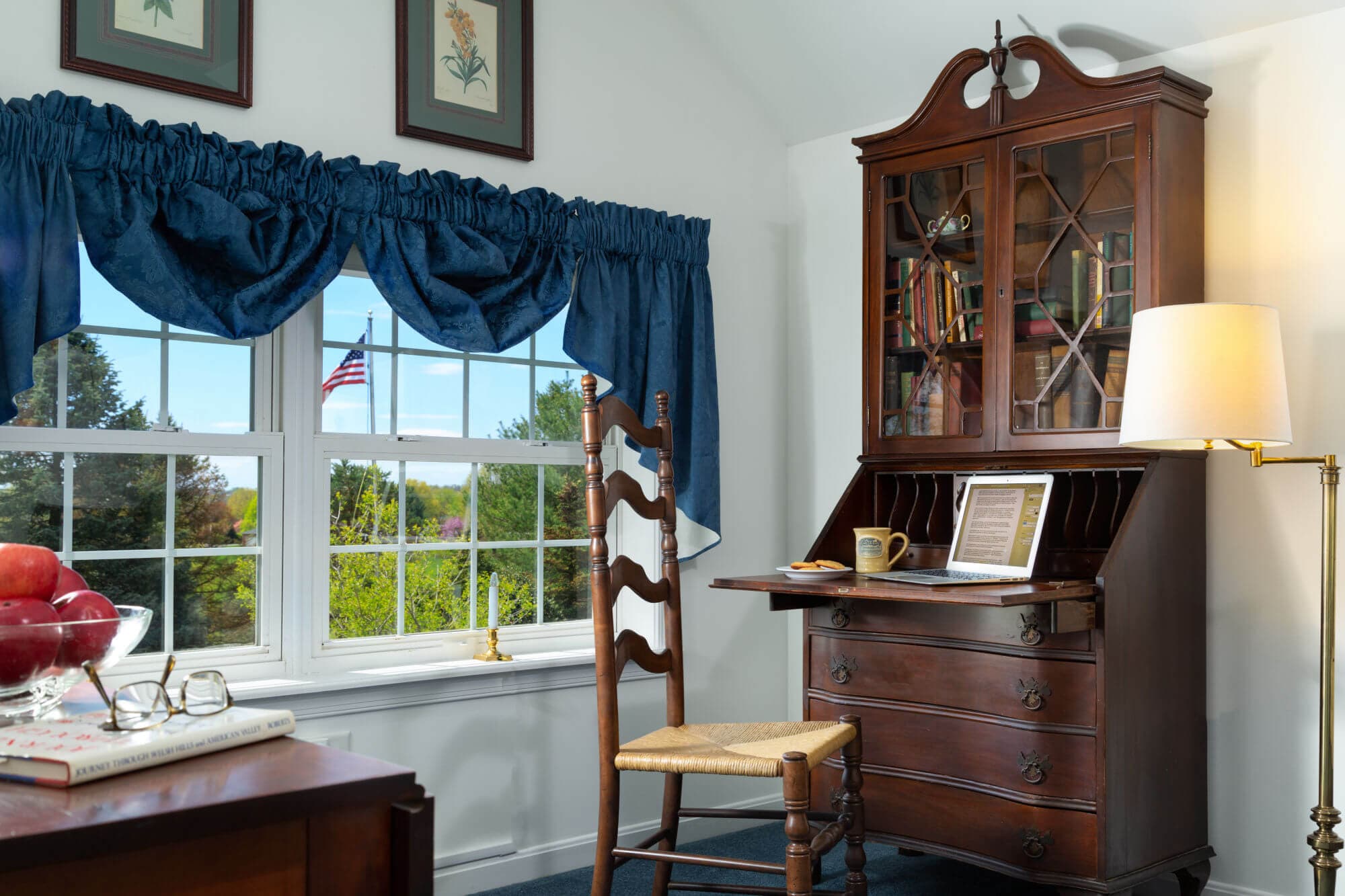 Desk, table and chair near windows