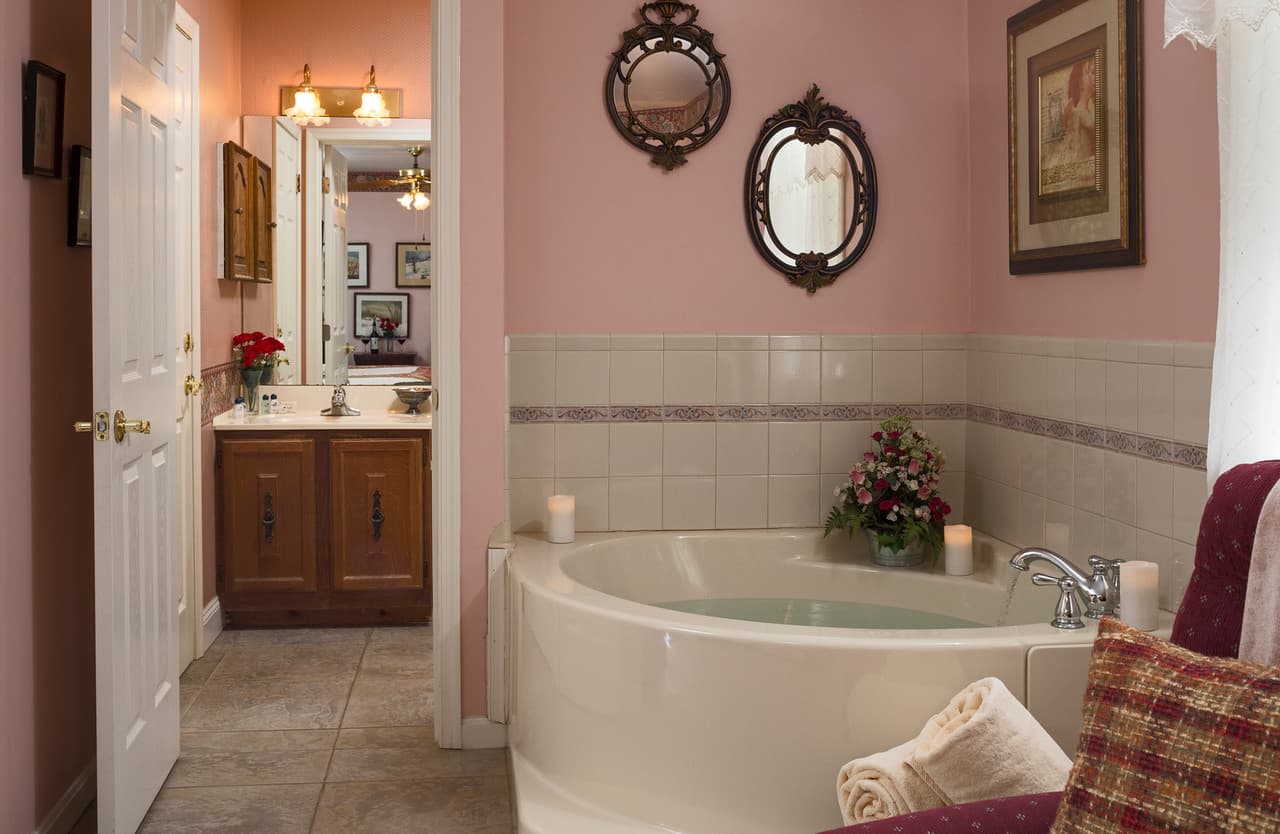 corner jacuzzi, pink walls, near bathroom