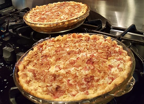 Two freshly baked pies cooling on a stovetop.