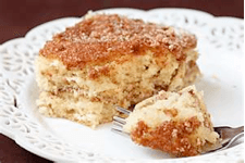 Slice of crumb cake on a decorative plate with a fork.