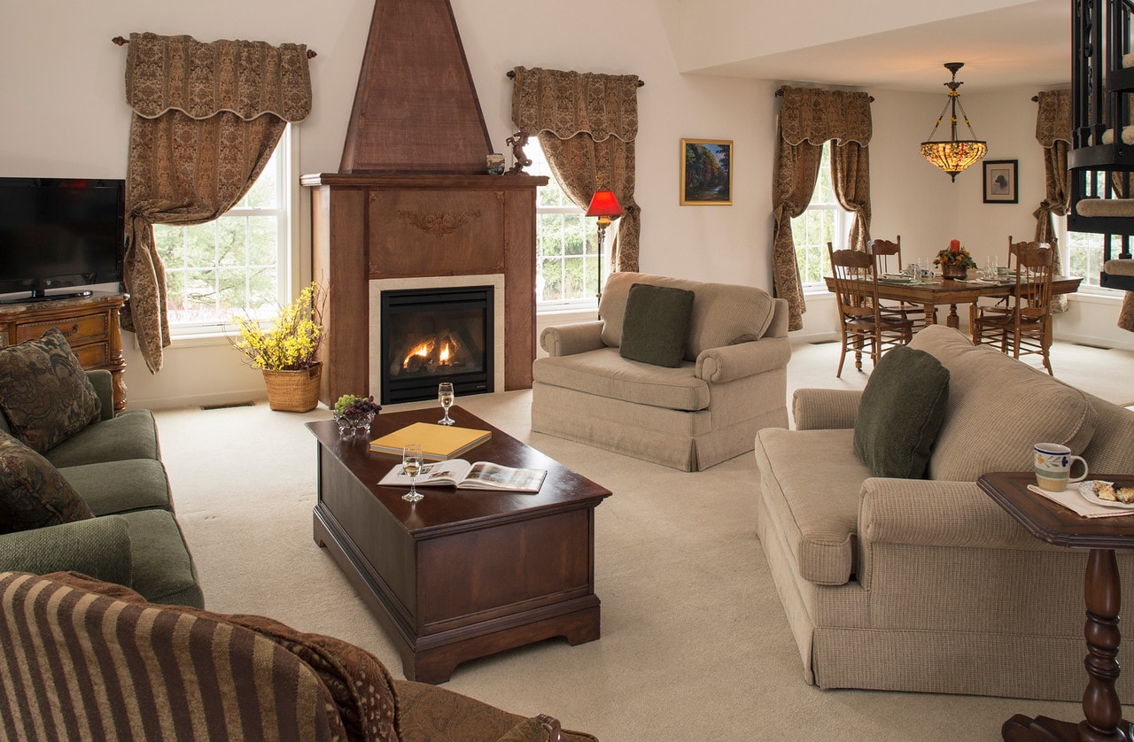 couch, chairs and coffee table near fireplace