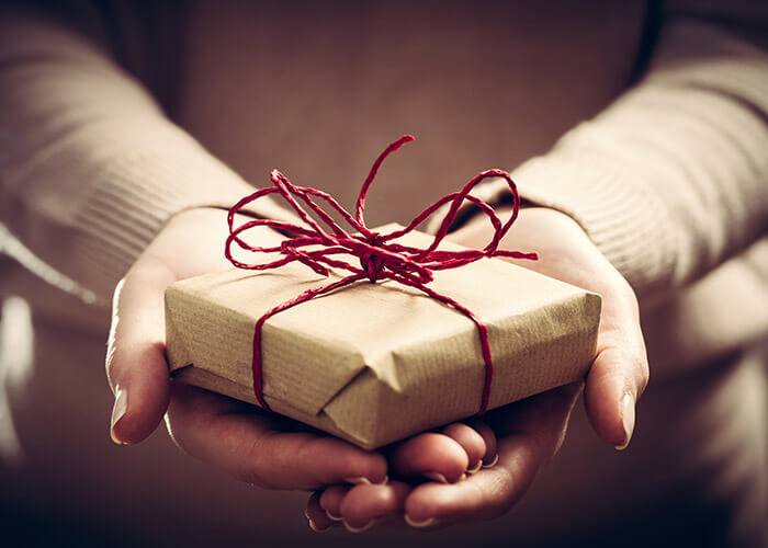 Hands holding a small gift box