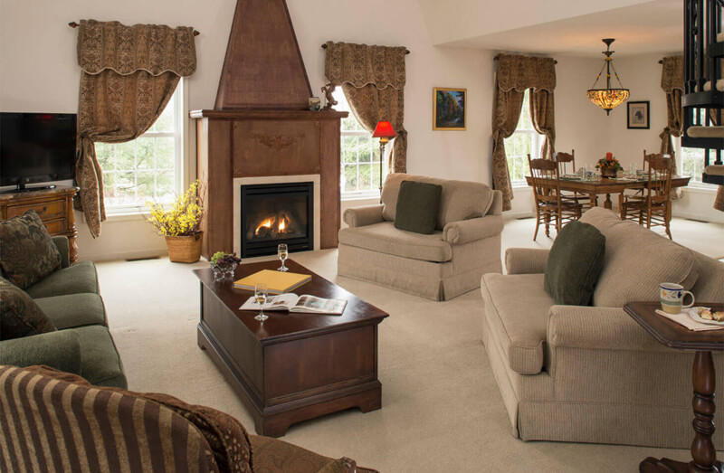 Luxurious hotel vacation rental with living room with fireplace