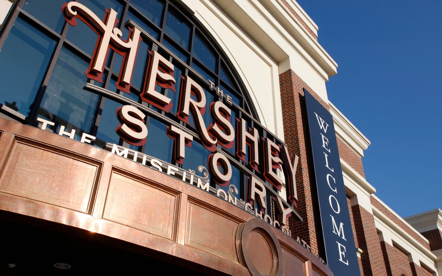 view of building's front entrance sign that says "the hershey story the museum on chocolate, welcome"